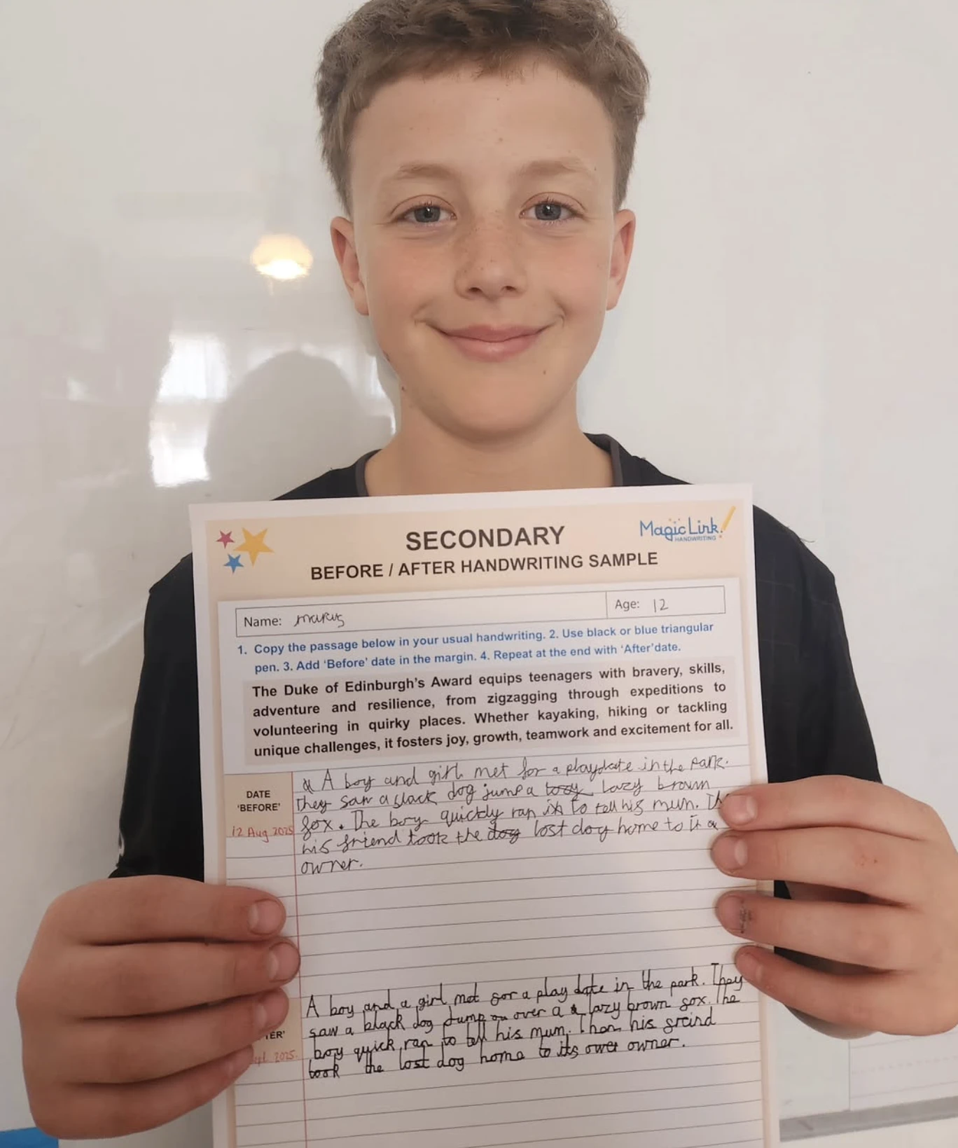 A secondary school pupil holding his before and after handwriting sample